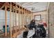 Interior room under construction with exposed studs and framing with a ceiling fan at 302 E Oakland Ave, Oakland, FL 34760