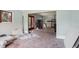 Open-concept living room boasts large windows, hardwood floors, and a spacious layout at 302 E Oakland Ave, Oakland, FL 34760