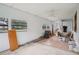 Large living room with original windows, and furniture covered with construction debris at 302 E Oakland Ave, Oakland, FL 34760
