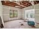 Living room under construction with exposed ceiling and walls and original wood windows at 302 E Oakland Ave, Oakland, FL 34760