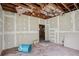 Living room under construction with exposed ceiling and walls with a blue trash can at 302 E Oakland Ave, Oakland, FL 34760