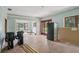 Spacious living room with hardwood floors, large windows, and vintage trim at 302 E Oakland Ave, Oakland, FL 34760