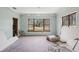 Bright living room features a large window with vintage trim and hardwood floors at 302 E Oakland Ave, Oakland, FL 34760