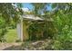 A small, secluded outbuilding sits surrounded by lush overgrowth, blending into its natural setting at 302 E Oakland Ave, Oakland, FL 34760