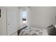 A bedroom featuring a bed with soccer-themed bedding, a bright window with sheer curtains, and a closet door at 33668 Seattle Slew Dr, Sorrento, FL 32776