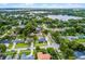 Aerial view of a single-Gathering home with mature trees, a long driveway, and a lush lawn near a lake at 3601 S Summerlin Ave, Orlando, FL 32806