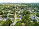 A panoramic aerial showcasing the home's location amid mature trees in a suburban community near a lake at 3601 S Summerlin Ave, Orlando, FL 32806