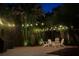 The backyard features beautiful string lights, attractive pavers, and lush landscaping at 3601 S Summerlin Ave, Orlando, FL 32806