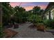 Outdoor patio with lush landscaping, string lights, and ample seating for relaxing and entertaining at 3601 S Summerlin Ave, Orlando, FL 32806