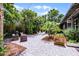 A tropical backyard features attractive stone pavers and luxurious greenery at 3601 S Summerlin Ave, Orlando, FL 32806