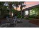 Outdoor patio with string lights, mature trees, and a fountain creating a cozy backyard retreat at 3601 S Summerlin Ave, Orlando, FL 32806