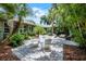 Backyard featuring string lights, attractive pavers, and lush tropical landscaping at 3601 S Summerlin Ave, Orlando, FL 32806