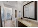 Elegant bathroom with granite vanity, modern fixtures and travertine tile flooring at 3601 S Summerlin Ave, Orlando, FL 32806
