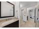 Bathroom featuring a granite vanity, tile floors, and a doorway leading to a bedroom at 3601 S Summerlin Ave, Orlando, FL 32806