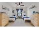 Charming bedroom with two twin beds, neutral decor, and a ceiling fan at 3601 S Summerlin Ave, Orlando, FL 32806