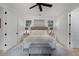 Bright bedroom features an upholstered headboard, ceiling fan, and plenty of natural light at 3601 S Summerlin Ave, Orlando, FL 32806