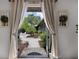 Inviting courtyard view with brick pavers, tropical landscaping and cozy seating area at 3601 S Summerlin Ave, Orlando, FL 32806