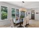 The dining room features large windows with views of tropical backyard landscaping at 3601 S Summerlin Ave, Orlando, FL 32806