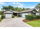 Charming home featuring an attractive brick driveway, two-car garage, and beautiful landscaping at 3601 S Summerlin Ave, Orlando, FL 32806