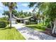 Charming home with lush landscaping, brick driveway, and mature trees, perfect for serene living at 3601 S Summerlin Ave, Orlando, FL 32806