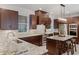 Gourmet kitchen featuring elegant countertops, rich wood cabinetry, and stainless steel appliances at 3601 S Summerlin Ave, Orlando, FL 32806
