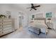 Comfortable main bedroom with neutral tones, ceiling fan, and access to an en-suite bathroom at 3601 S Summerlin Ave, Orlando, FL 32806