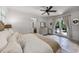 Serene main bedroom with french doors to backyard, neutral decor, and access to en-suite bathroom at 3601 S Summerlin Ave, Orlando, FL 32806