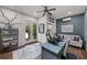 Modern office features a custom desk, couch, and french doors leading to the outside at 3601 S Summerlin Ave, Orlando, FL 32806