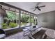 Covered patio featuring brick flooring, a ceiling fan, and a table with benches overlooking the lush garden at 3601 S Summerlin Ave, Orlando, FL 32806