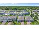 An aerial view of a neighborhood featuring well-maintained homes, green lawns, and mature trees at 410 Winter Bliss Ln, Mount Dora, FL 32757