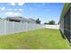 Well-maintained backyard with a white fence, offering privacy and space at 410 Winter Bliss Ln, Mount Dora, FL 32757
