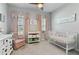 Bedroom with grey walls, plush carpeting, complemented by soft, pink accents and white furniture at 410 Winter Bliss Ln, Mount Dora, FL 32757