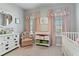 Bedroom with grey walls, plush carpeting, complemented by soft, pink accents and white furniture at 410 Winter Bliss Ln, Mount Dora, FL 32757