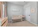 Charming Bedroom with grey walls, plush carpeting, a white crib, and soft, pink accents at 410 Winter Bliss Ln, Mount Dora, FL 32757