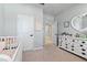 Bedroom with grey walls, plush carpeting, complemented by soft, pink accents and white furniture at 410 Winter Bliss Ln, Mount Dora, FL 32757