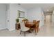 Dining room with hardwood table, tiled floor, and neutral paint color at 410 Winter Bliss Ln, Mount Dora, FL 32757