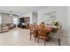 Open-concept dining area with tile flooring, view of living room, and contemporary decor at 410 Winter Bliss Ln, Mount Dora, FL 32757