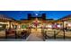 An inviting exterior night view of The Factory with string lights and outdoor seating at 410 Winter Bliss Ln, Mount Dora, FL 32757