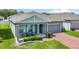 Charming one-story home with a brick driveway, covered porch, and well-manicured landscaping at 410 Winter Bliss Ln, Mount Dora, FL 32757