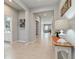 A bright hallway features neutral tones, tile flooring, and an open entryway to the living area at 410 Winter Bliss Ln, Mount Dora, FL 32757
