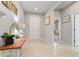 Neutral hallway with a console table, decorative accents, and doorways leading to other rooms at 410 Winter Bliss Ln, Mount Dora, FL 32757