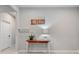 A clean hallway featuring neutral tones, a wooden table, and a simple decor at 410 Winter Bliss Ln, Mount Dora, FL 32757