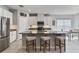 Stylish kitchen with granite countertops, an island with seating, stainless steel appliances, and white cabinetry at 410 Winter Bliss Ln, Mount Dora, FL 32757