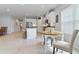 Open floor plan with kitchen island, dining space, and tile flooring throughout at 410 Winter Bliss Ln, Mount Dora, FL 32757