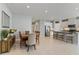 Open floor plan with kitchen island and dining space provides easy access to all living areas at 410 Winter Bliss Ln, Mount Dora, FL 32757