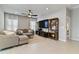 Comfortable living room with plush seating, neutral tones, open layout, and decorative wooden shelves at 410 Winter Bliss Ln, Mount Dora, FL 32757