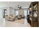 Bright living room with tile floors, modern furniture, ceiling fan, and natural light from the sliding doors at 410 Winter Bliss Ln, Mount Dora, FL 32757