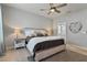 Inviting main bedroom with a king-sized bed, neutral tones, decorative bedside tables, and a serene ambiance at 410 Winter Bliss Ln, Mount Dora, FL 32757