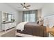 Elegant main bedroom with a comfortable bed, neutral decor, and ample natural light, creating a relaxing retreat at 410 Winter Bliss Ln, Mount Dora, FL 32757
