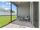 Relaxing screened patio featuring comfortable seating and a view of the fenced yard at 410 Winter Bliss Ln, Mount Dora, FL 32757